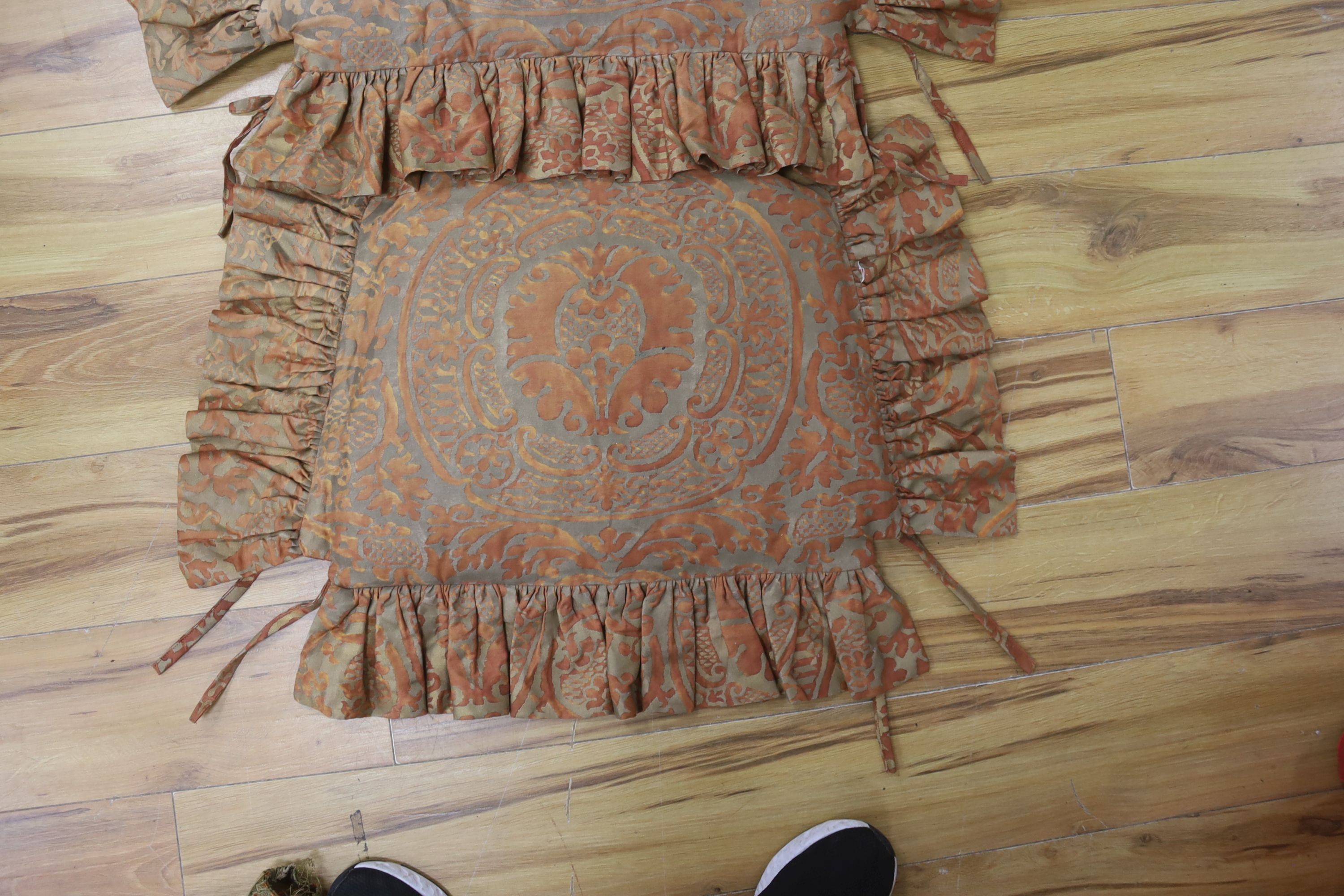 A pair of Fortuni 'Orsini pattern' seat cushions in rust and gold colourway